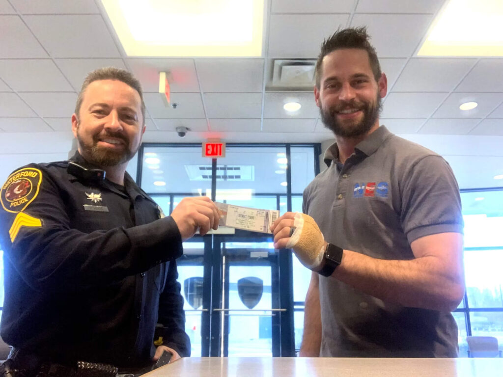 NES Plumbing team member supporting the local community with an Oxford police officer.