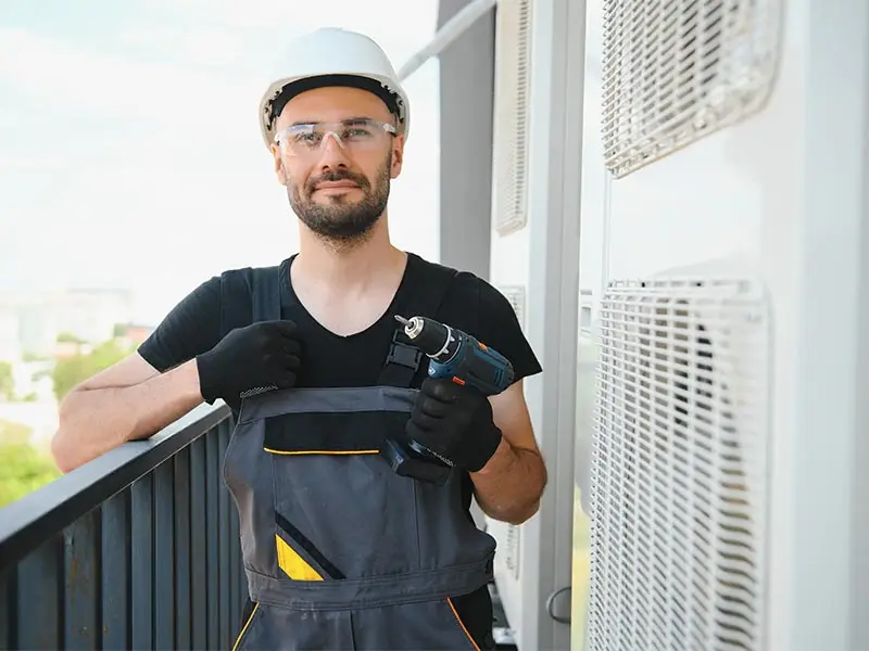 NES technician performing routine AC maintenance as part of a home care membership program