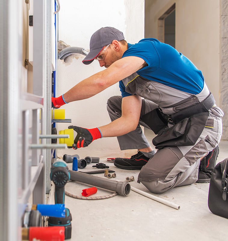 NES Plumbing technician working on a residential plumbing installation near Lake Orion, MI