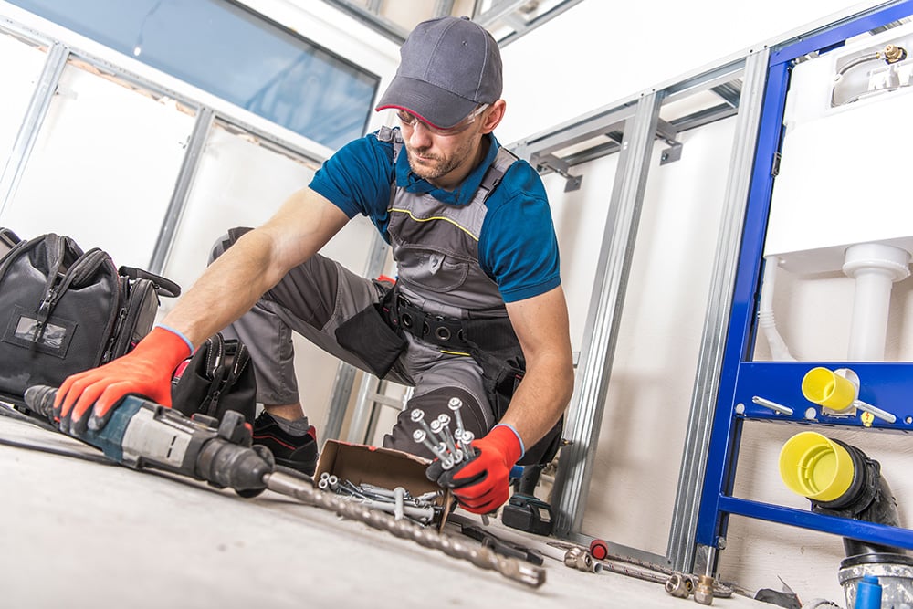 NES Plumbing technician performing commercial and residential plumbing installation work in Leonard, MI